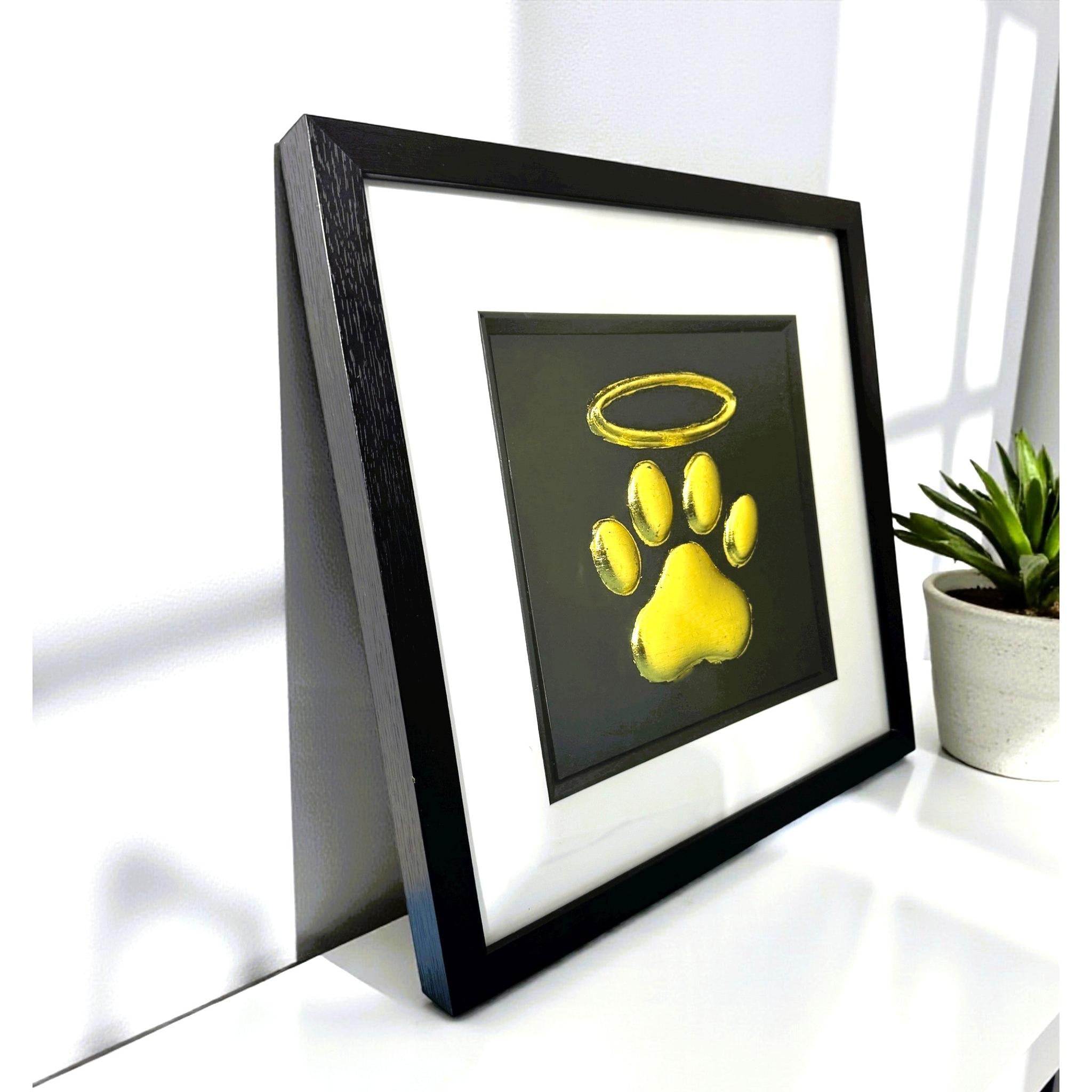 Angled view of dog paw halo memorial wall art showing depth and frame