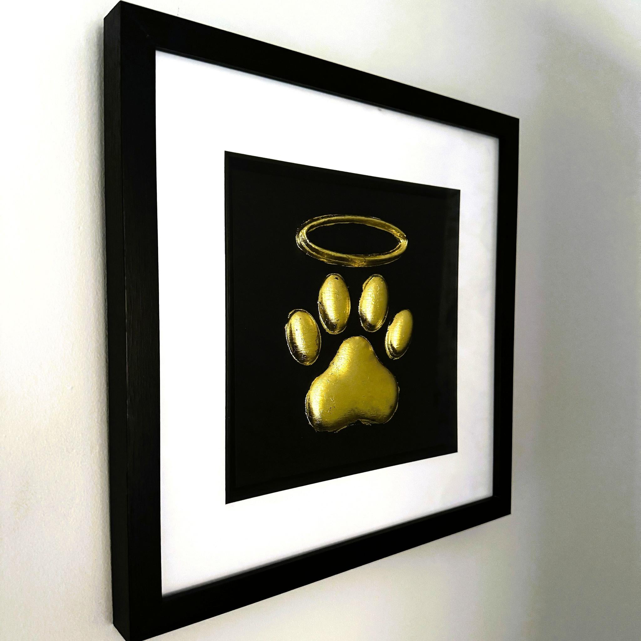 Close-up of raised dog paw print with halo finished in gold leaf