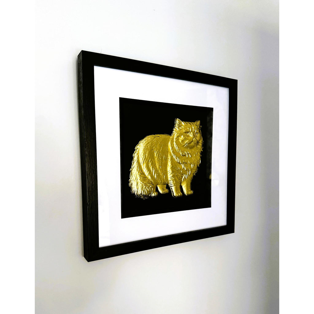Persian cat gold leaf framed wall art shown at an angle with black frame white mount and black background