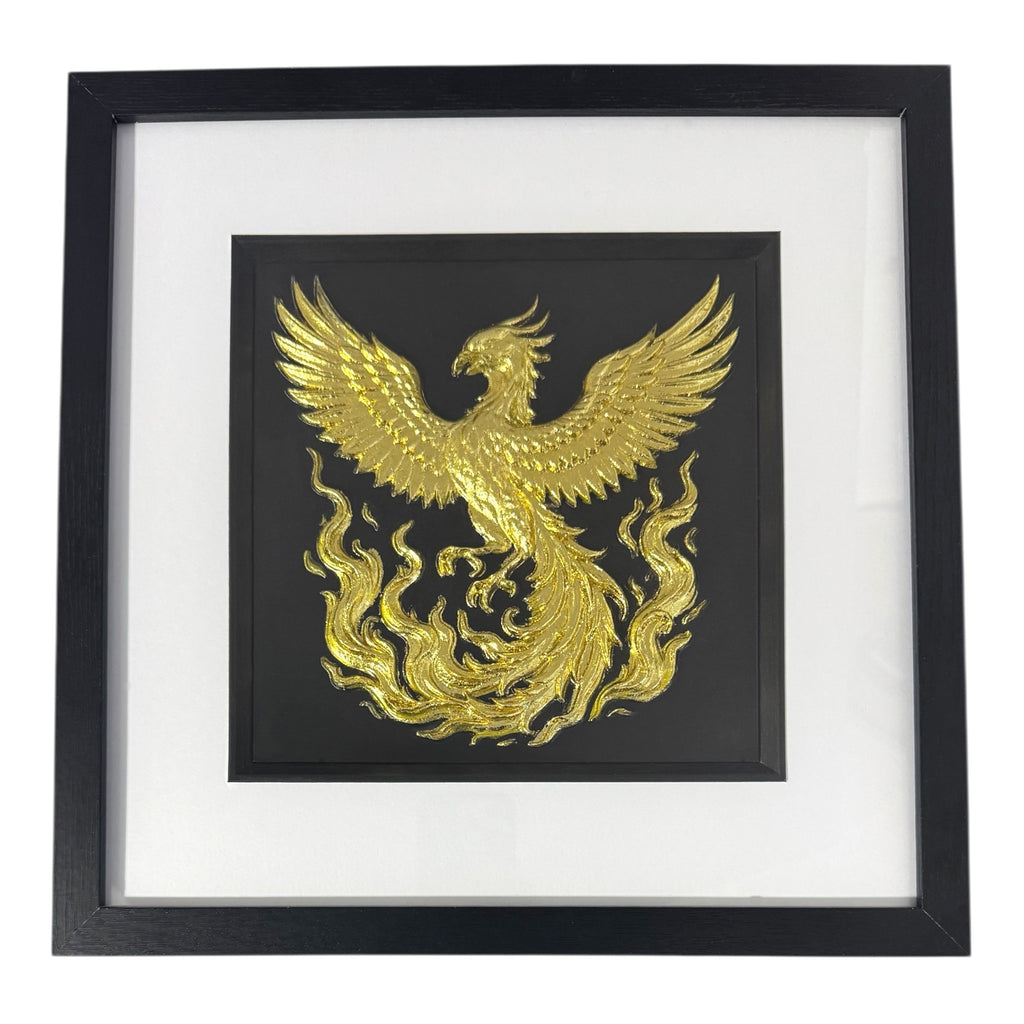 Gold phoenix rising wall art framed in black with white mount, raised phoenix wings and flowing flames on a black background