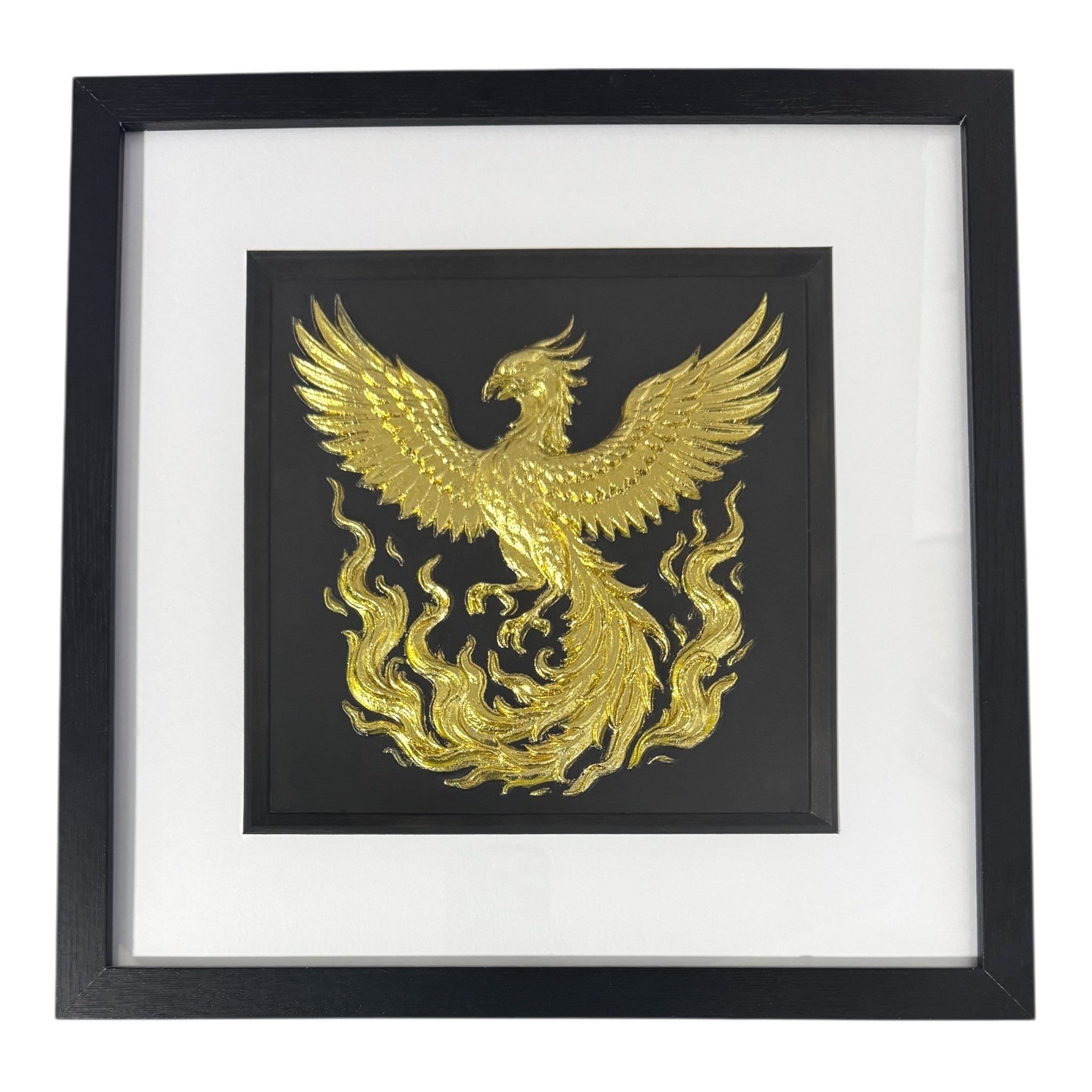 Gold phoenix rising wall art framed in black with white mount, raised phoenix wings and flowing flames on a black background