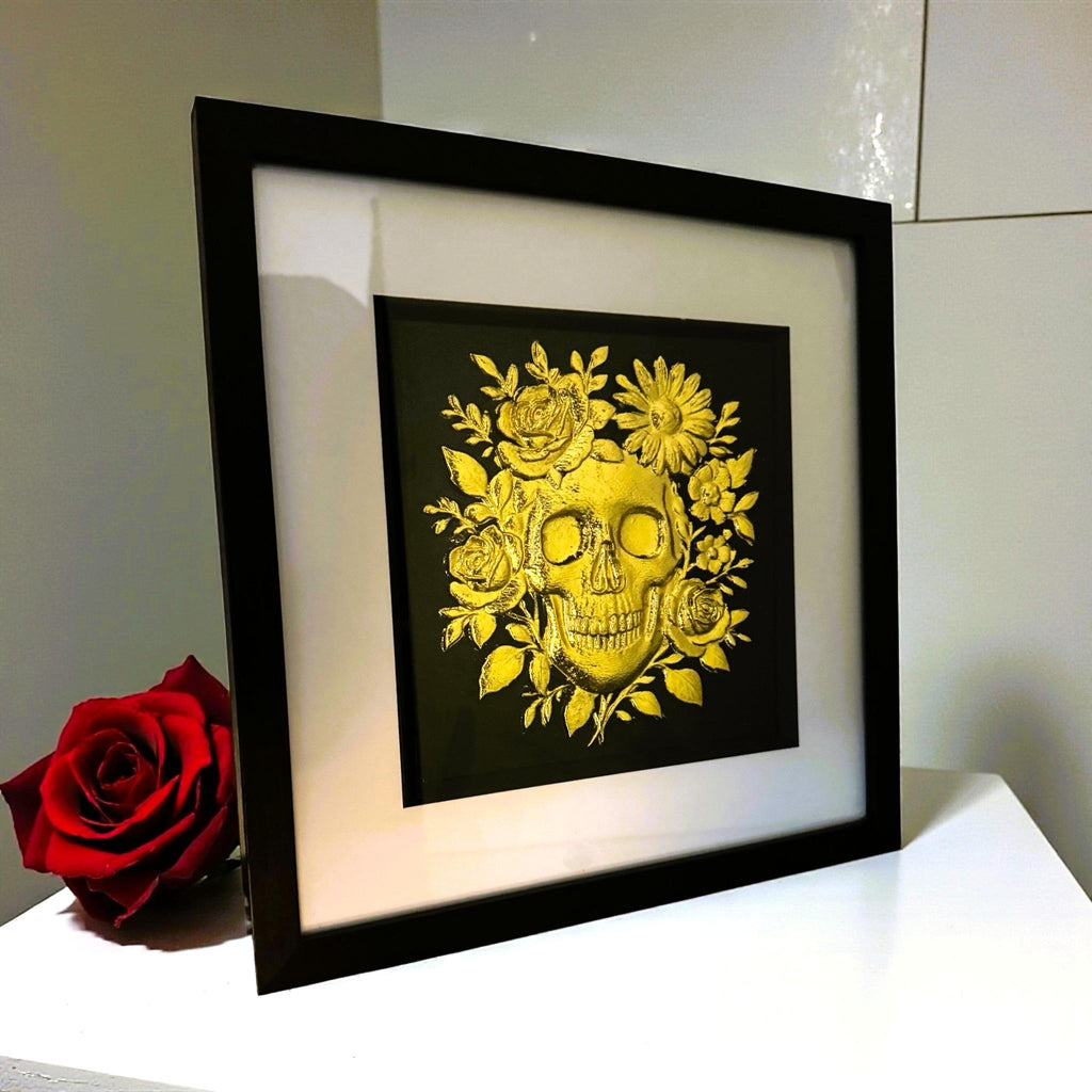 Close-up of skull and floral detailing finished in gold leaf