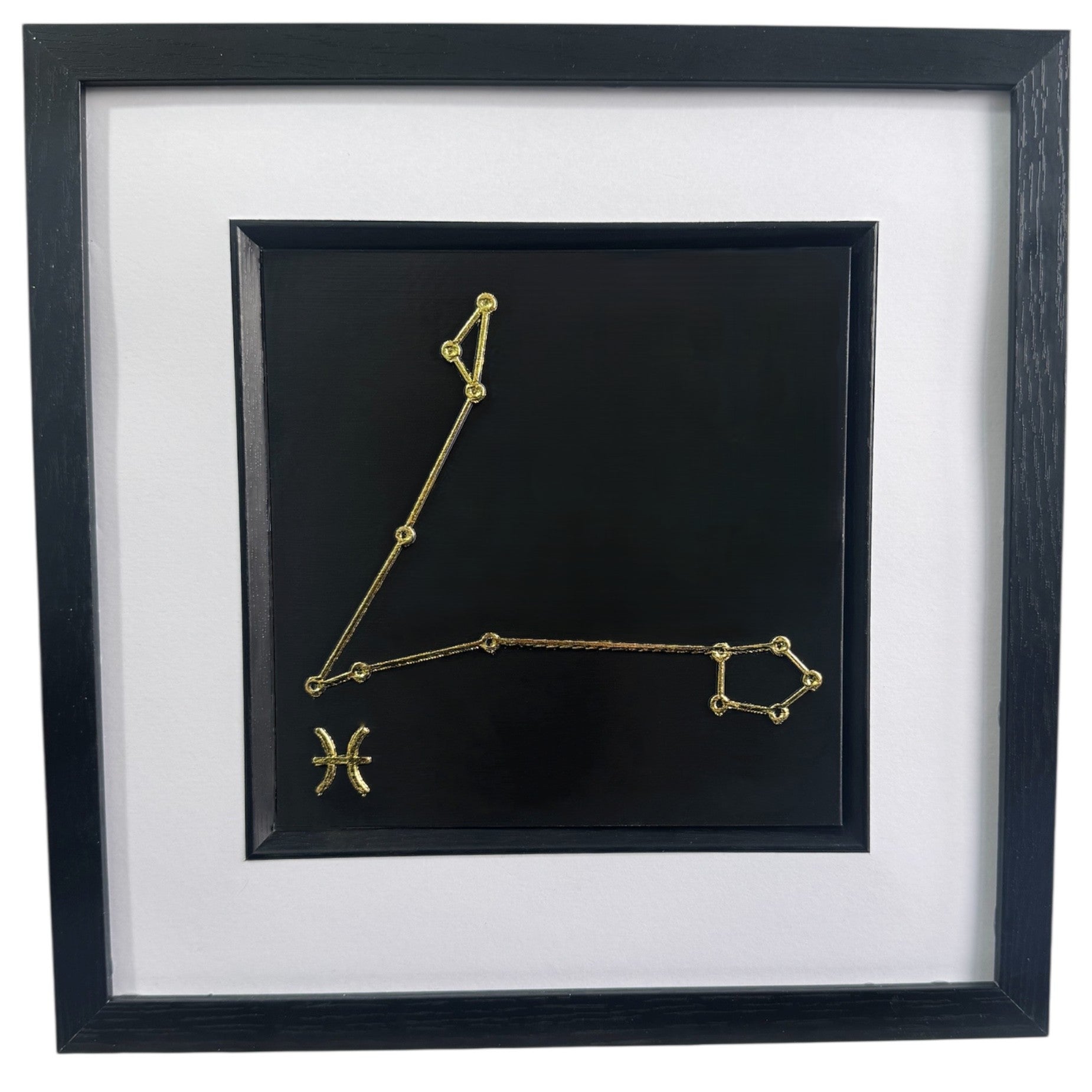 Gold Pisces constellation wall art on black background with white mount