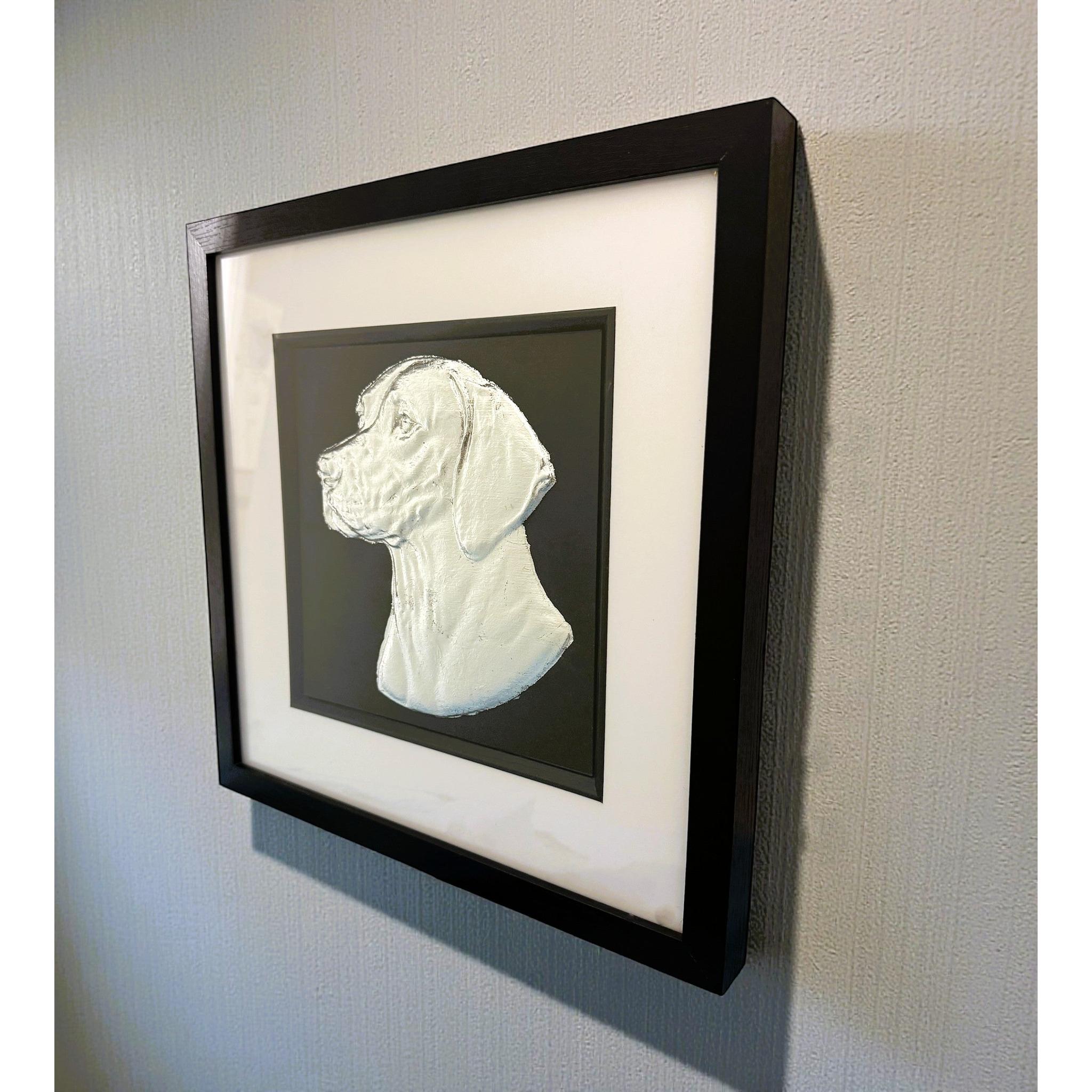 English Pointer framed wall art in silver leaf mounted on a wall, with black wooden frame, white mount, and black background
