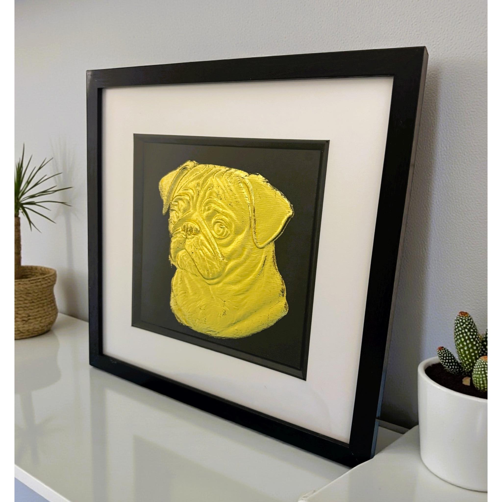 Pug gold leaf wall art photographed at an angle on a shelf with black frame and white mount