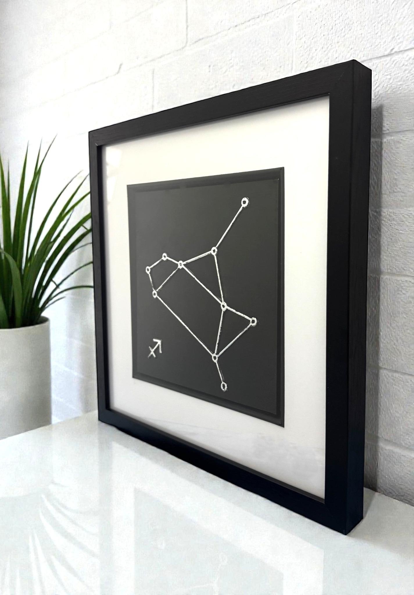Side view of framed Sagittarius constellation wall art showing depth
