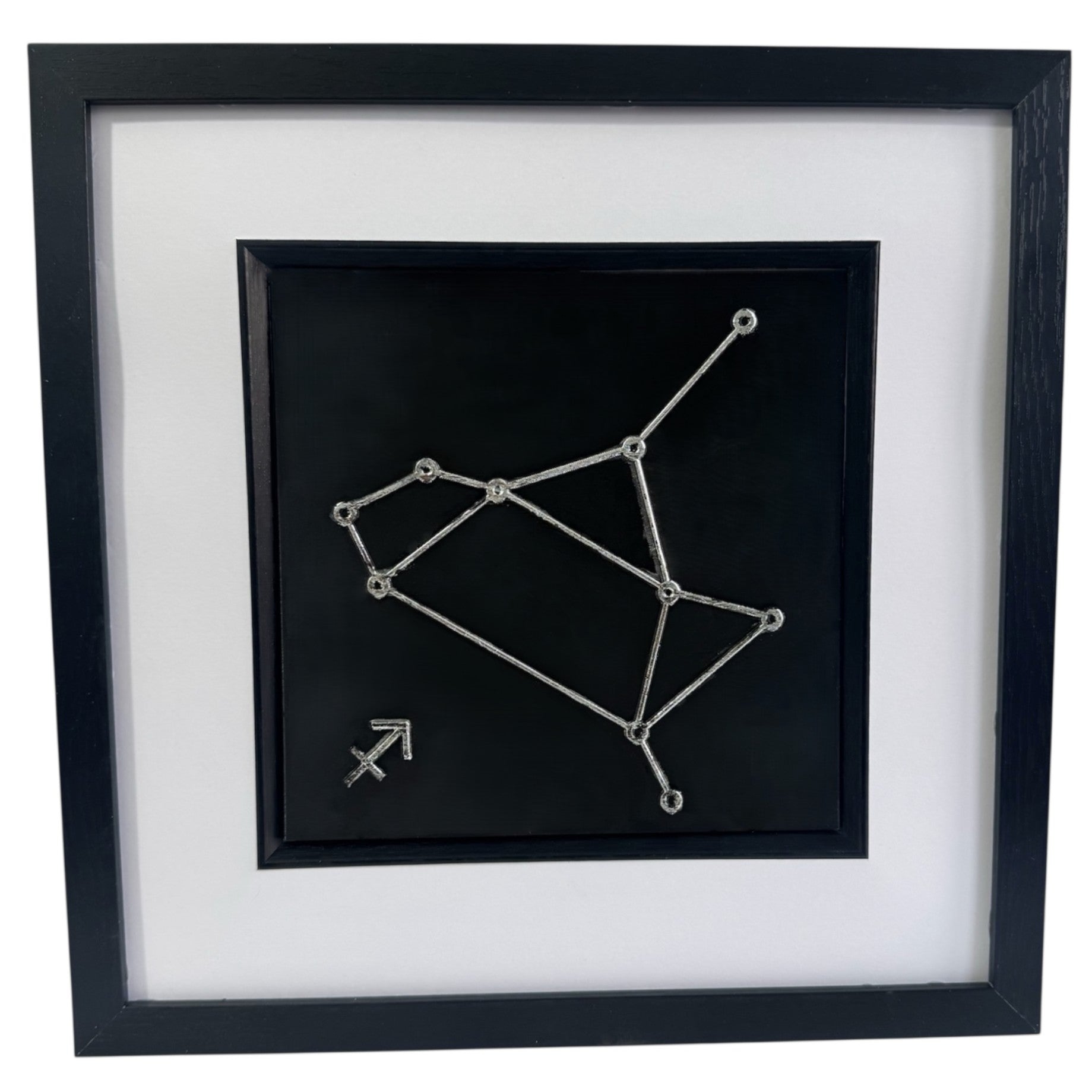 Silver Sagittarius constellation wall art on black background with white mount