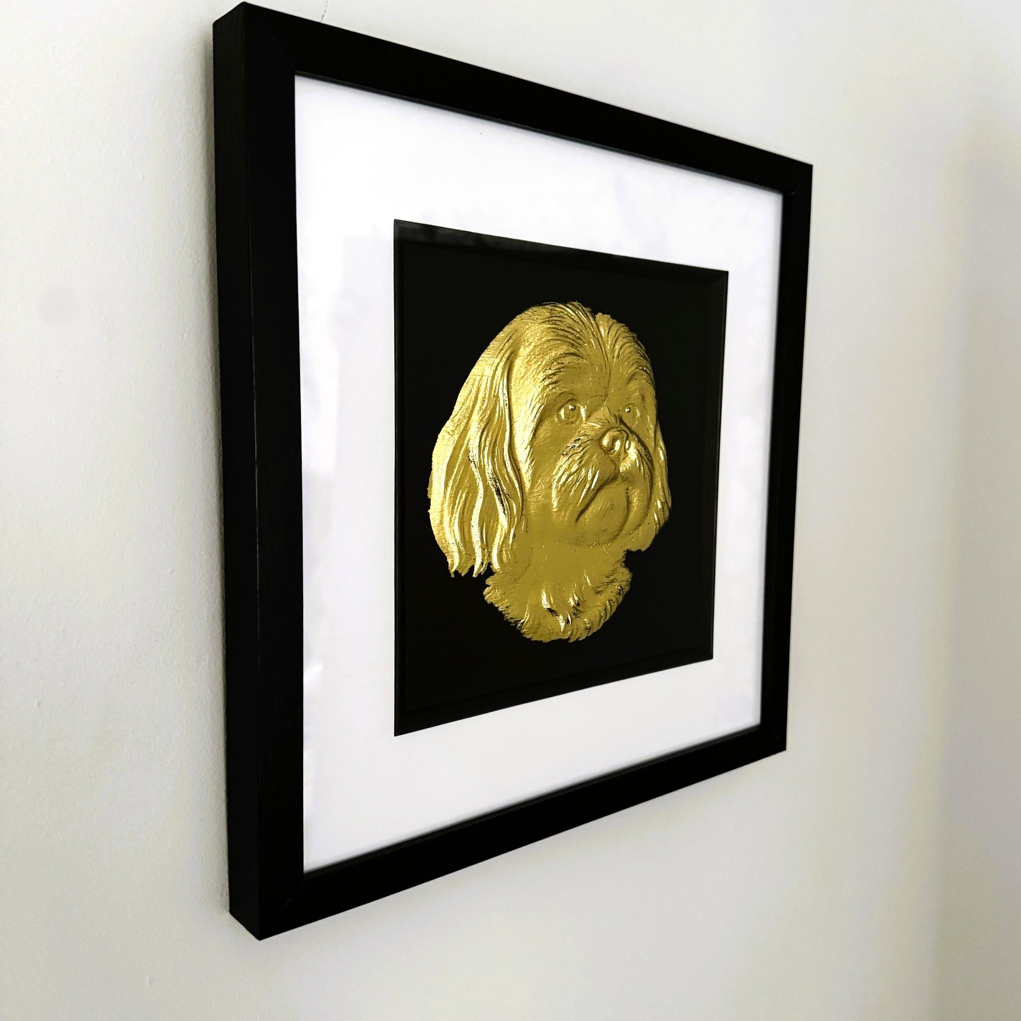 Shih Tzu gold leaf framed wall art mounted on a wall shown at a slight angle with black frame and white mount