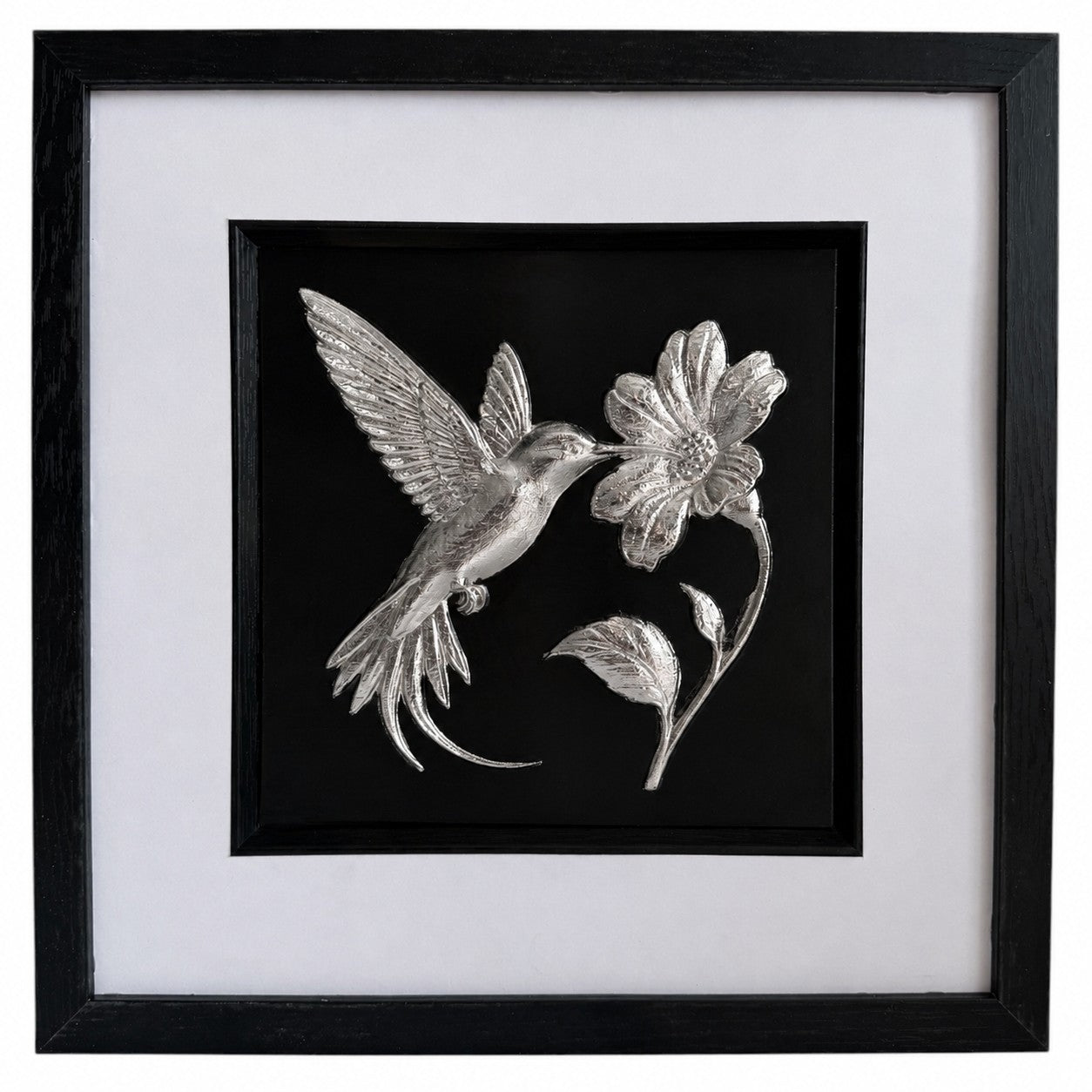 Front-facing silver leaf hummingbird and flower wall art with black background and white mount