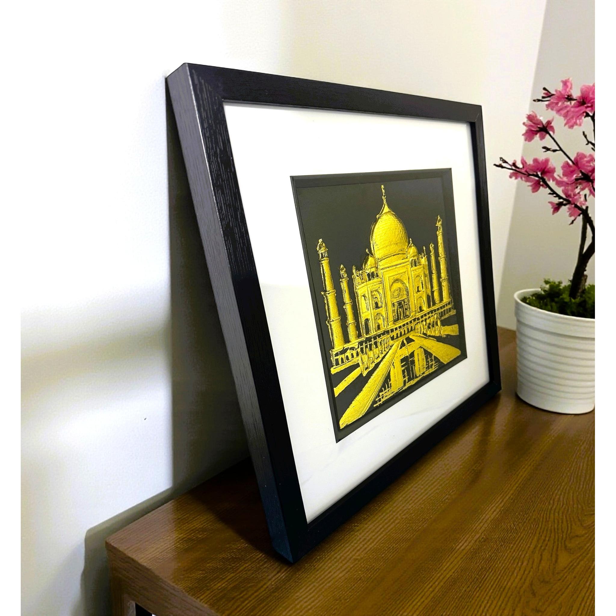 Framed Taj Mahal landmark artwork displayed on a desk
