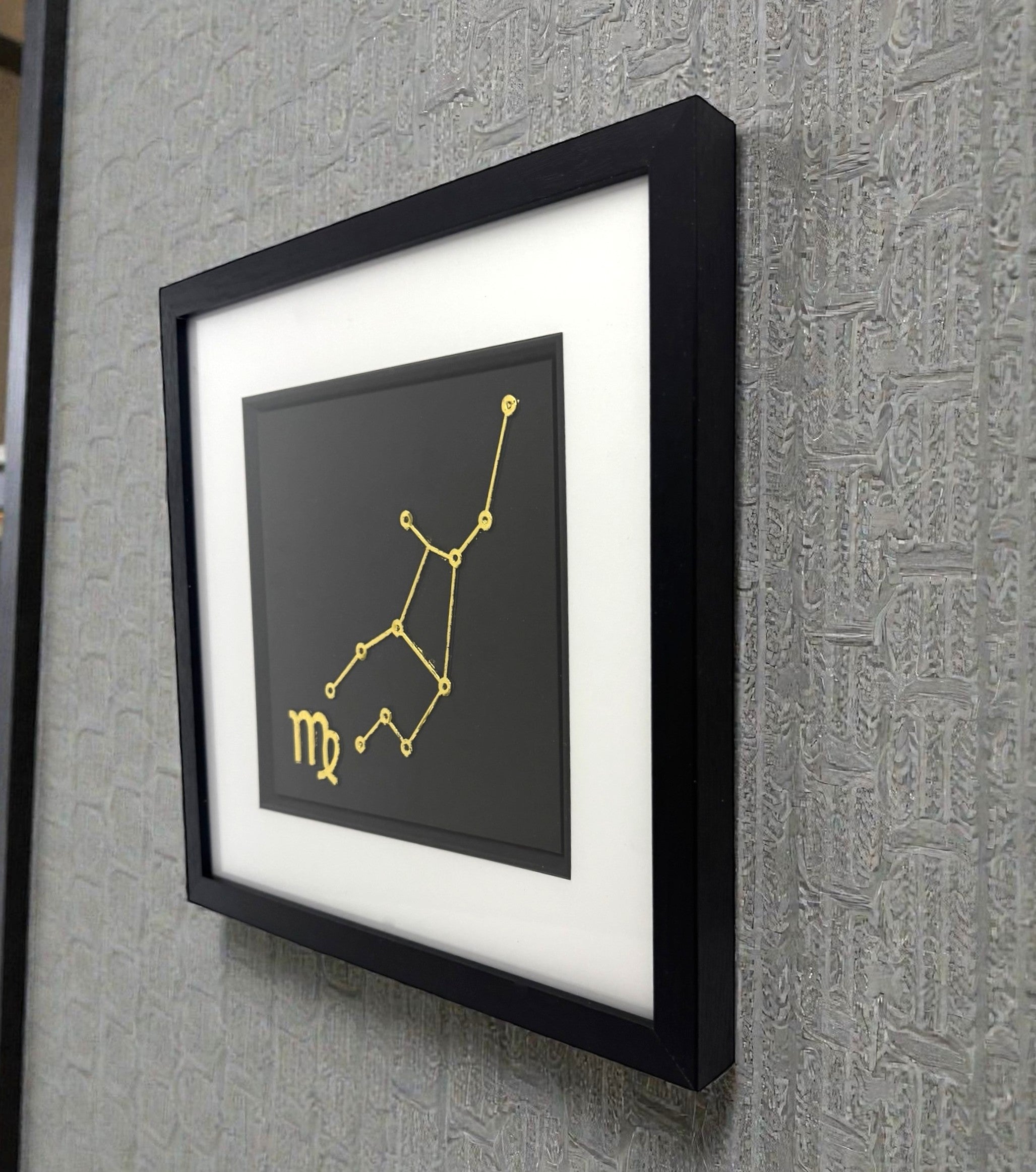 Virgo constellation wall art displayed on wall in black frame