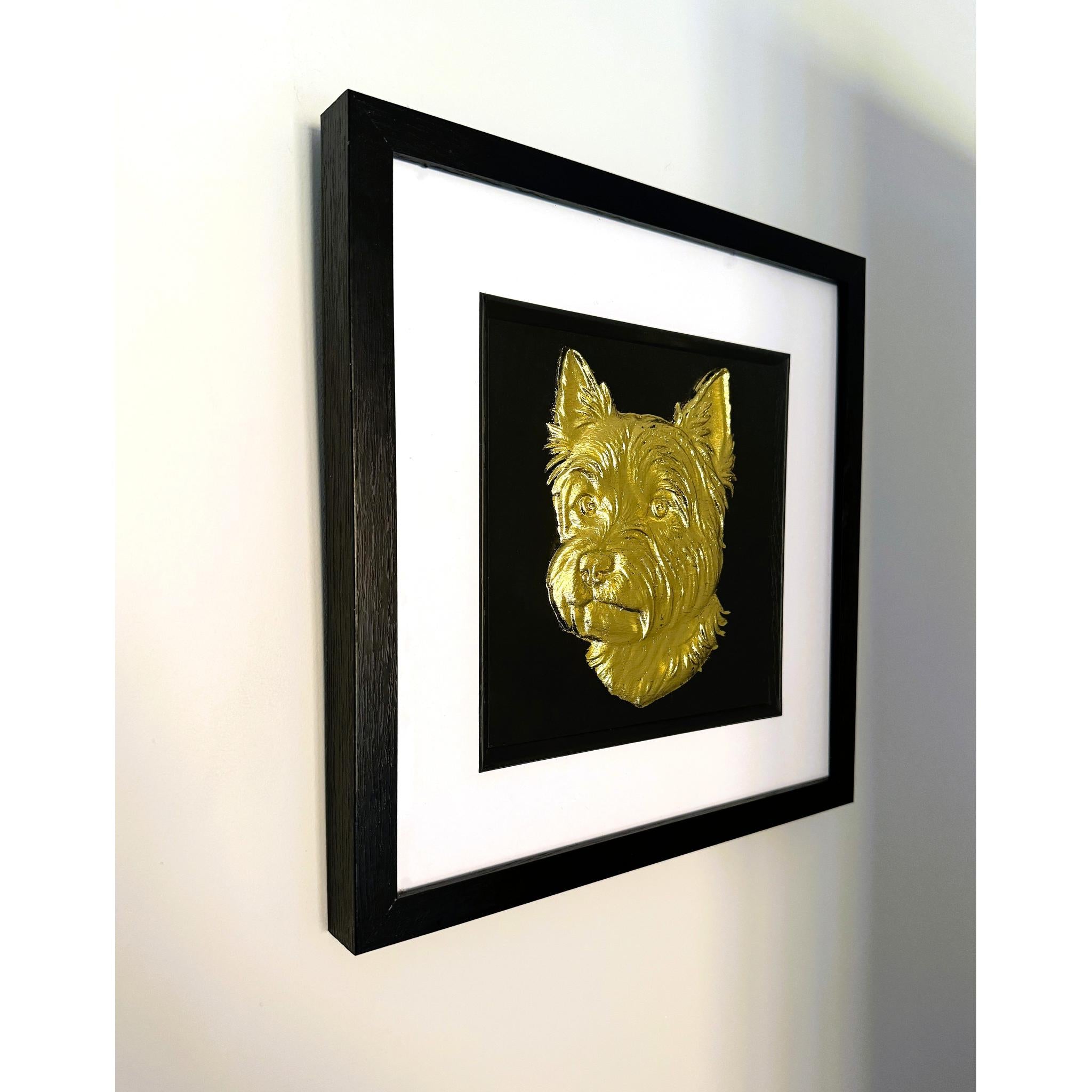 West Highland White Terrier framed wall art in gold leaf shown mounted on a wall with black wooden frame and white mount