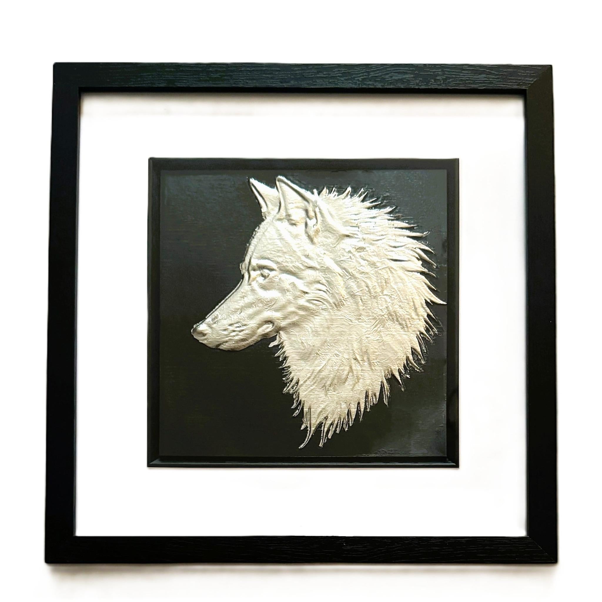 Silver wolf head wall art framed in black with white mount on black background