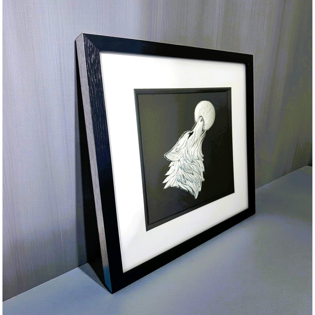 Angled side view of wolf howling moon wall art showing black frame depth and leaf detail