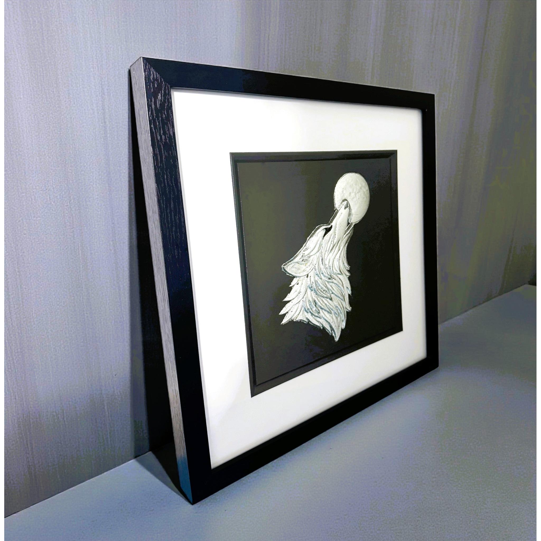 Angled side view of wolf howling moon wall art showing black frame depth and leaf detail