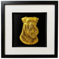 Framed Airedale Terrier wall art, gold relief portrait with folded ears and beard on a black background, black wooden frame with white mount, on a white background