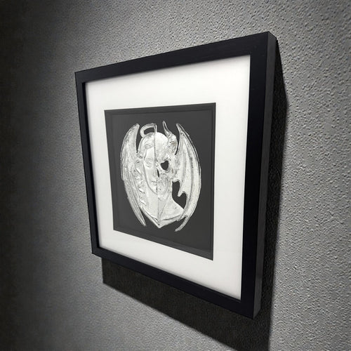 Framed angel and demon wall art displayed on wall