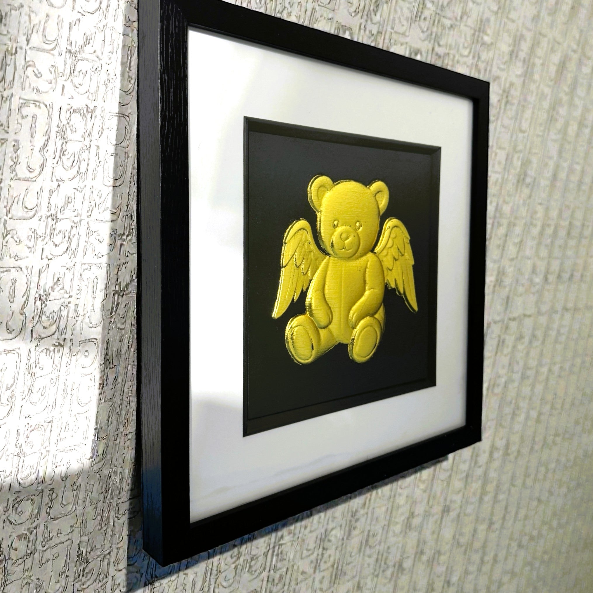 Side view of angel teddy bear memorial wall art in black frame