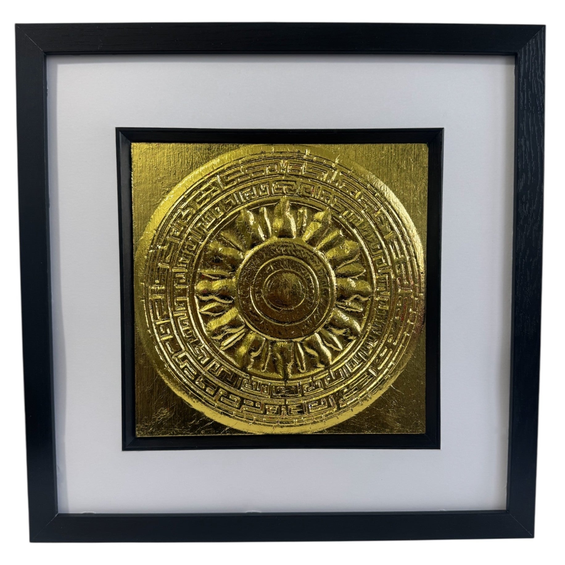 Front-facing gold leaf Aztec Sunstone wall art centred in a black wooden frame with white mount