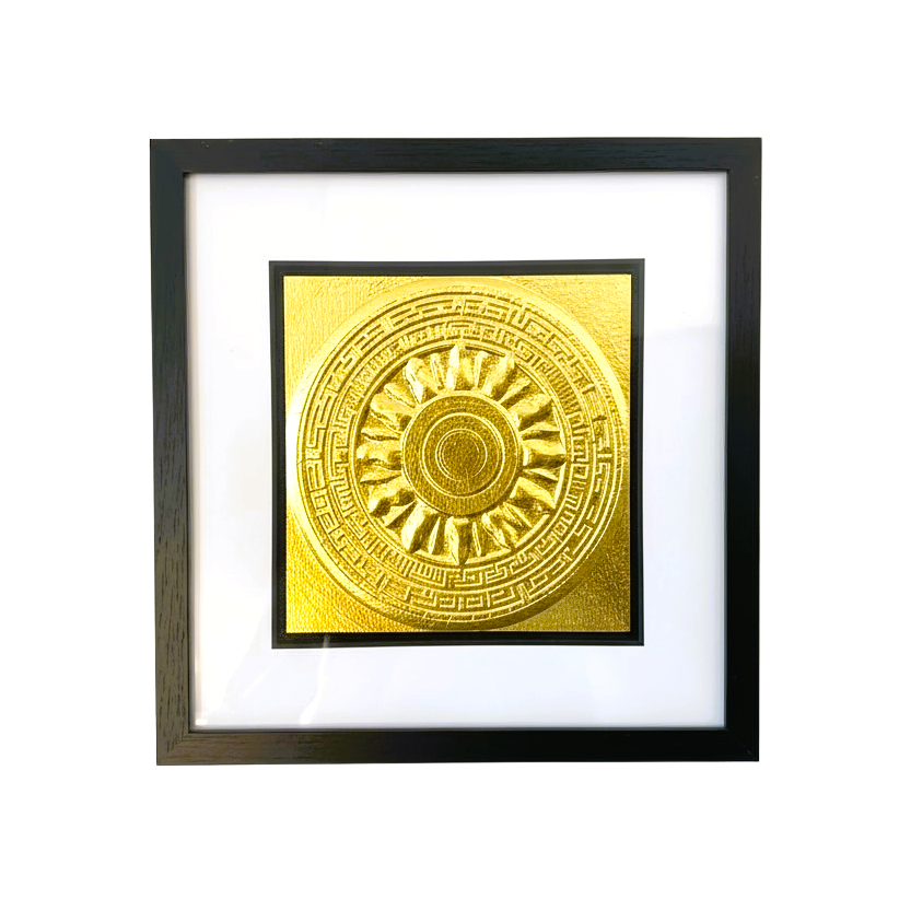 Front-facing gold leaf Aztec Sunstone wall art centred in a black wooden frame with white mount