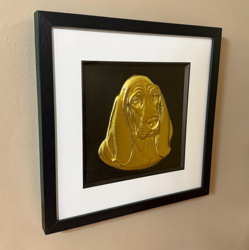 Gold Basset Hound 3D wall art hanging on a cream textured wall, viewed from the side to show the depth of the black box frame and the raised relief of the ears