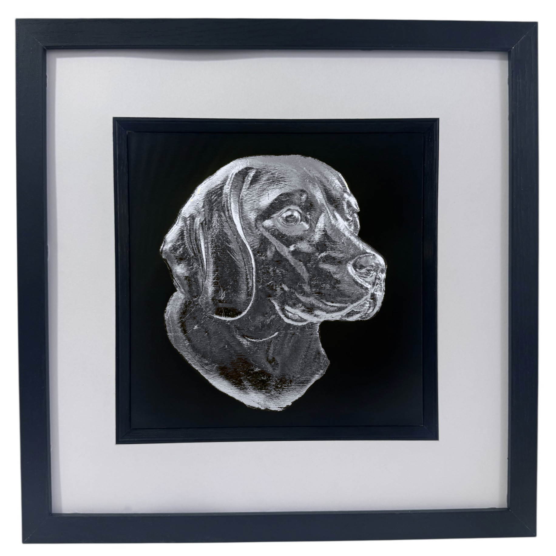 Framed beagle wall art with silver relief portrait on a black background, set in a black frame with white mount, photographed on a pure white background