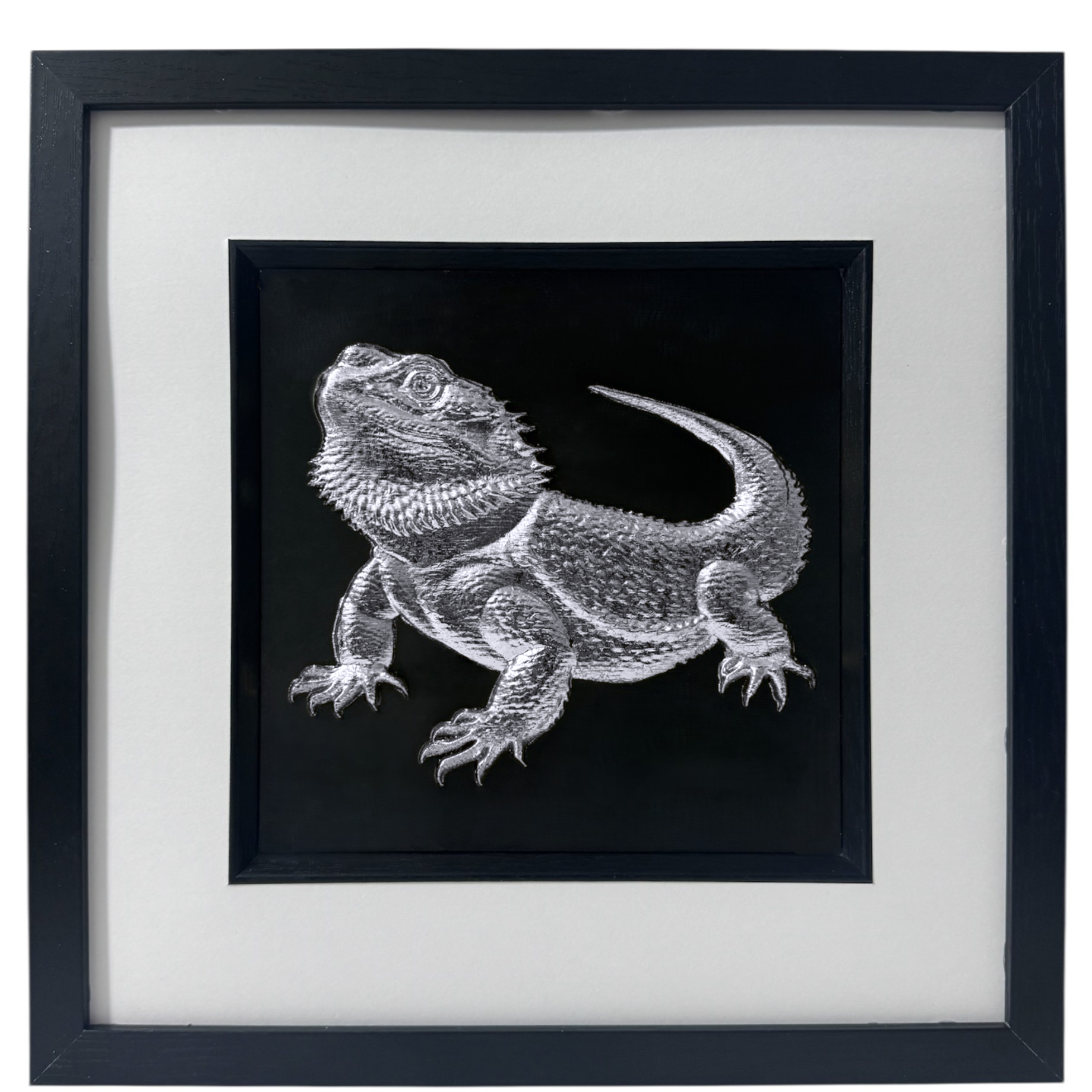 A handmade 3D Bearded Dragon wall art piece finished in bright metallic silver leaf, showing the textured scales in a black box frame.