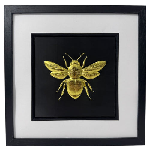Front-facing gold leaf bumble bee wall art with black background and white mount
