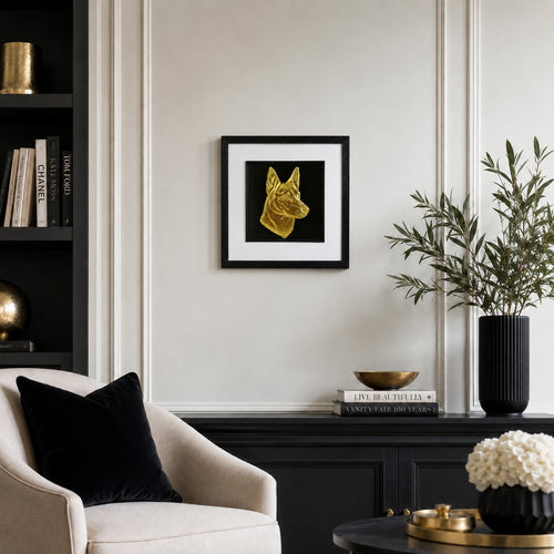 Belgian Malinois gold leaf framed wall art displayed on a cream panelled living room wall with black and gold luxury decor accents.