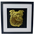 Framed border collie wall art in gold leaf relief, centred on a black background with white mount and black wooden frame
