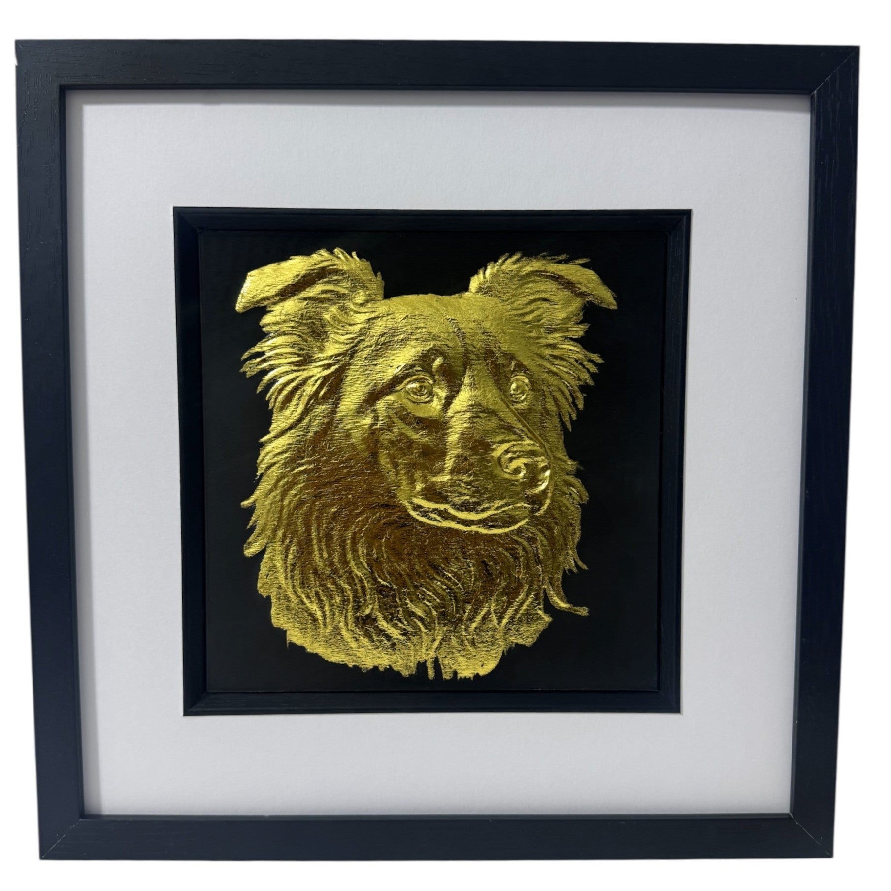 Framed border collie wall art in gold leaf relief, centred on a black background with white mount and black wooden frame