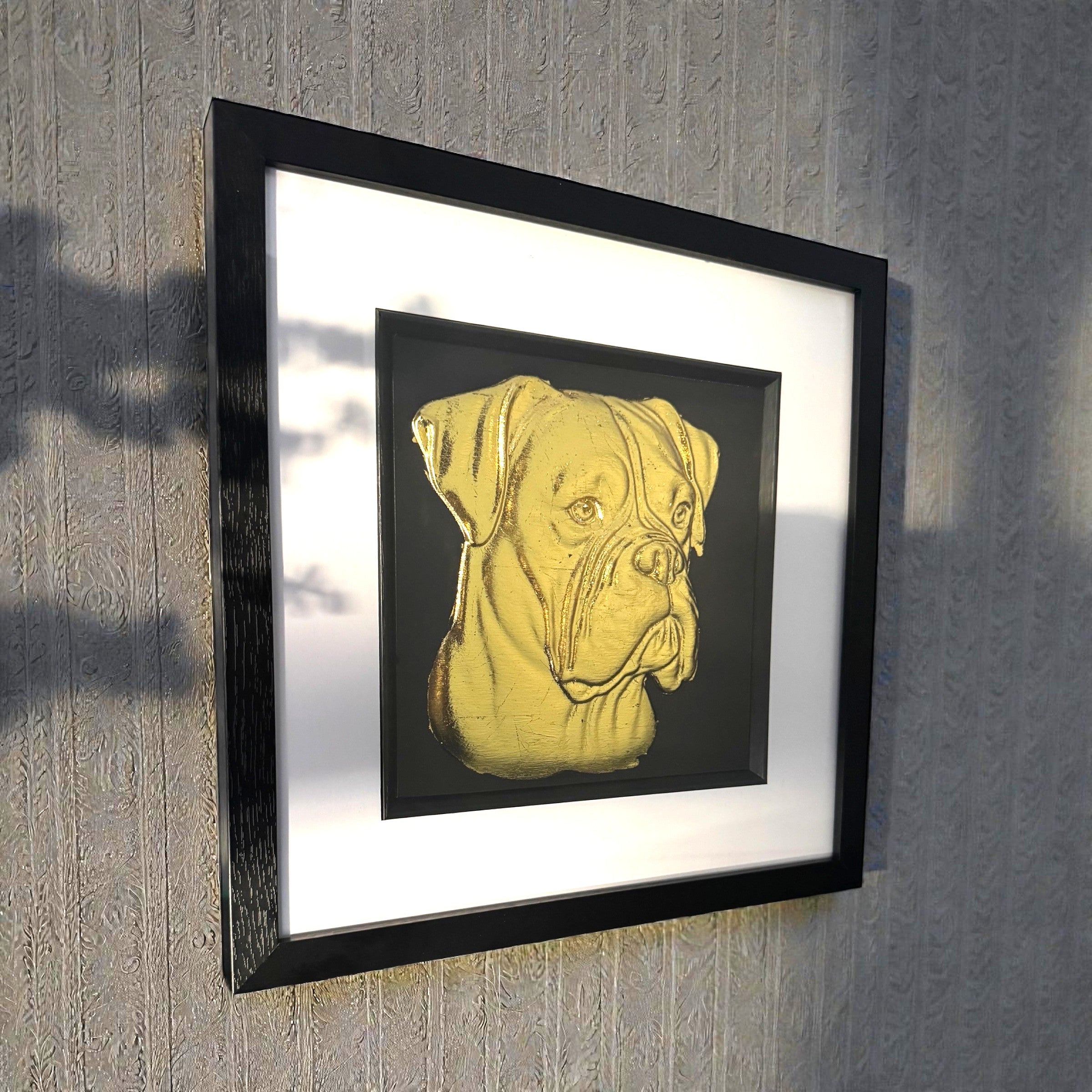 Boxer gold leaf framed wall art displayed on a wall interior