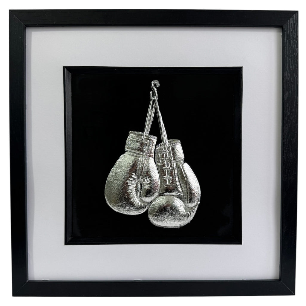 Framed 3D silver leaf boxing gloves wall art. Handmade relief sculpture of hanging gloves on a black background. Luxury sports gift for boxers and gym decor.