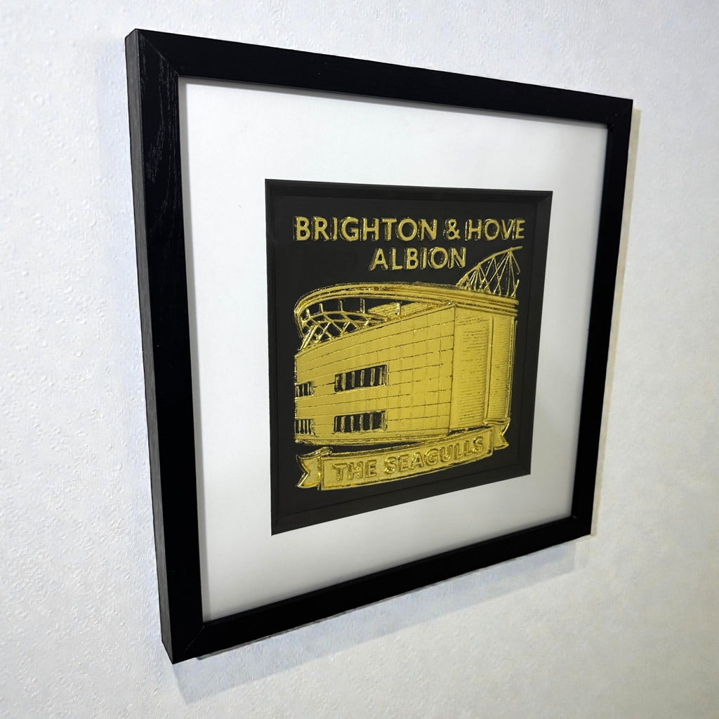 Brighton and Hove Albion football gift framed Amex Stadium wall art in gold leaf displayed on a wall
