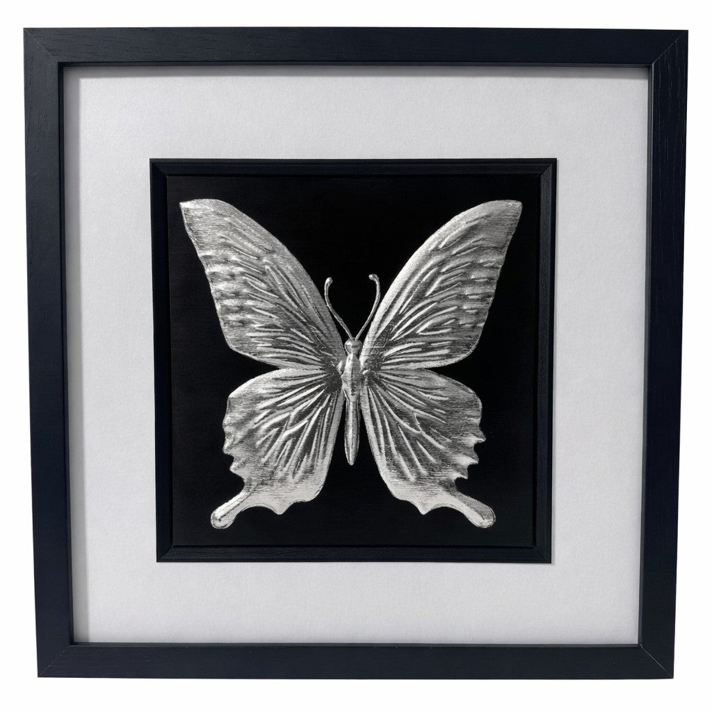 Silver butterfly wall art framed in black with white mount