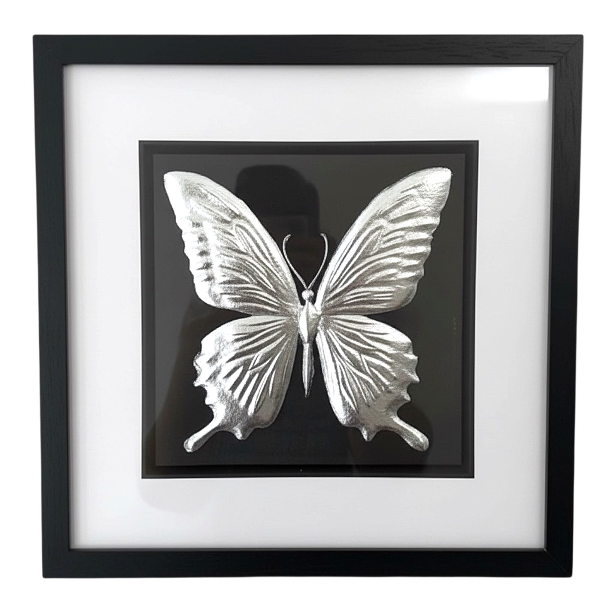 Silver butterfly wall art framed in black with white mount