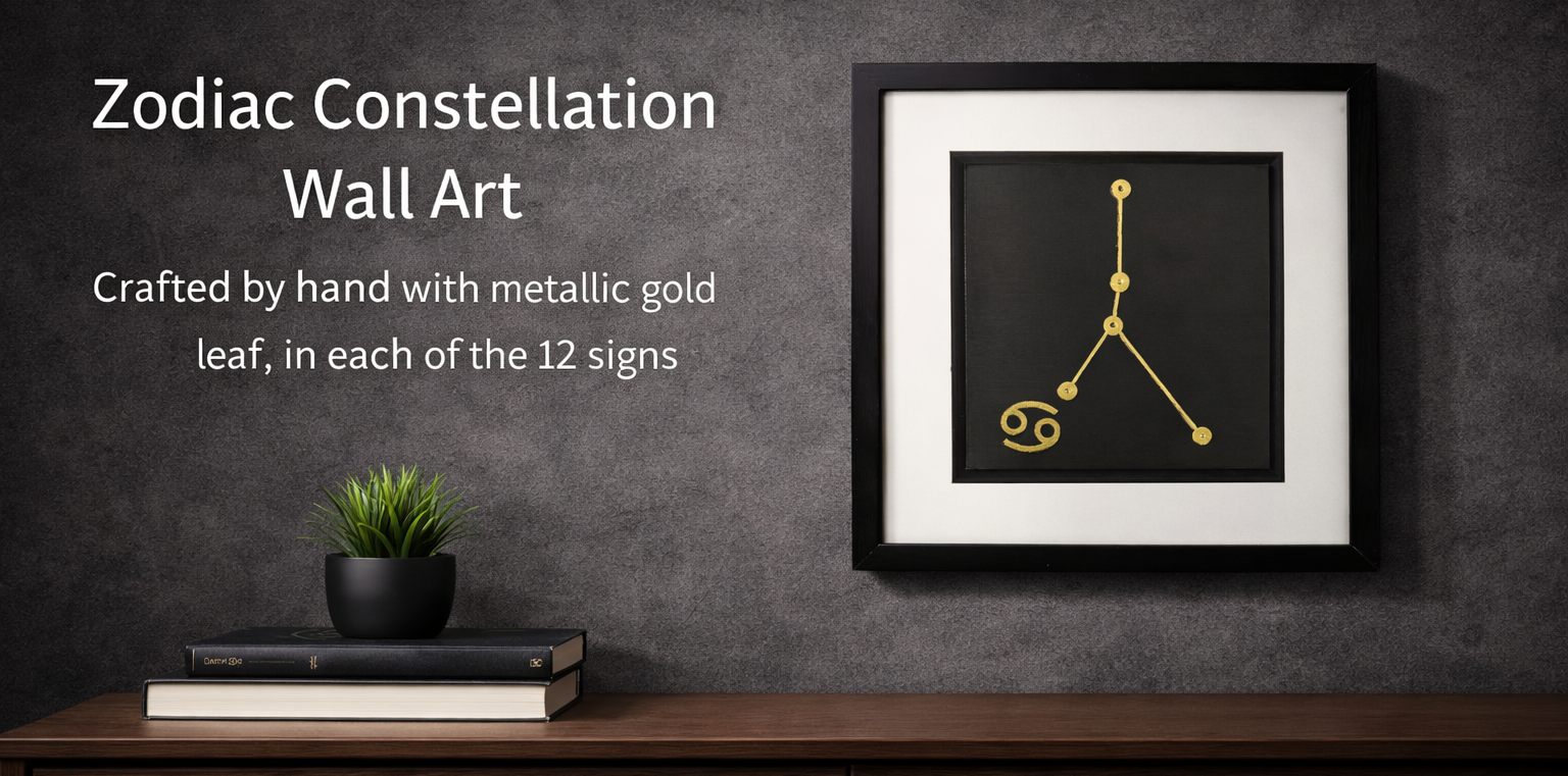 Hero banner for JP Designs Zodiac Constellation collection showing a framed Cancer constellation wall art in gold leaf on a dark charcoal textured wall above a walnut console with stacked books and a small plant, with overlay text on the left.