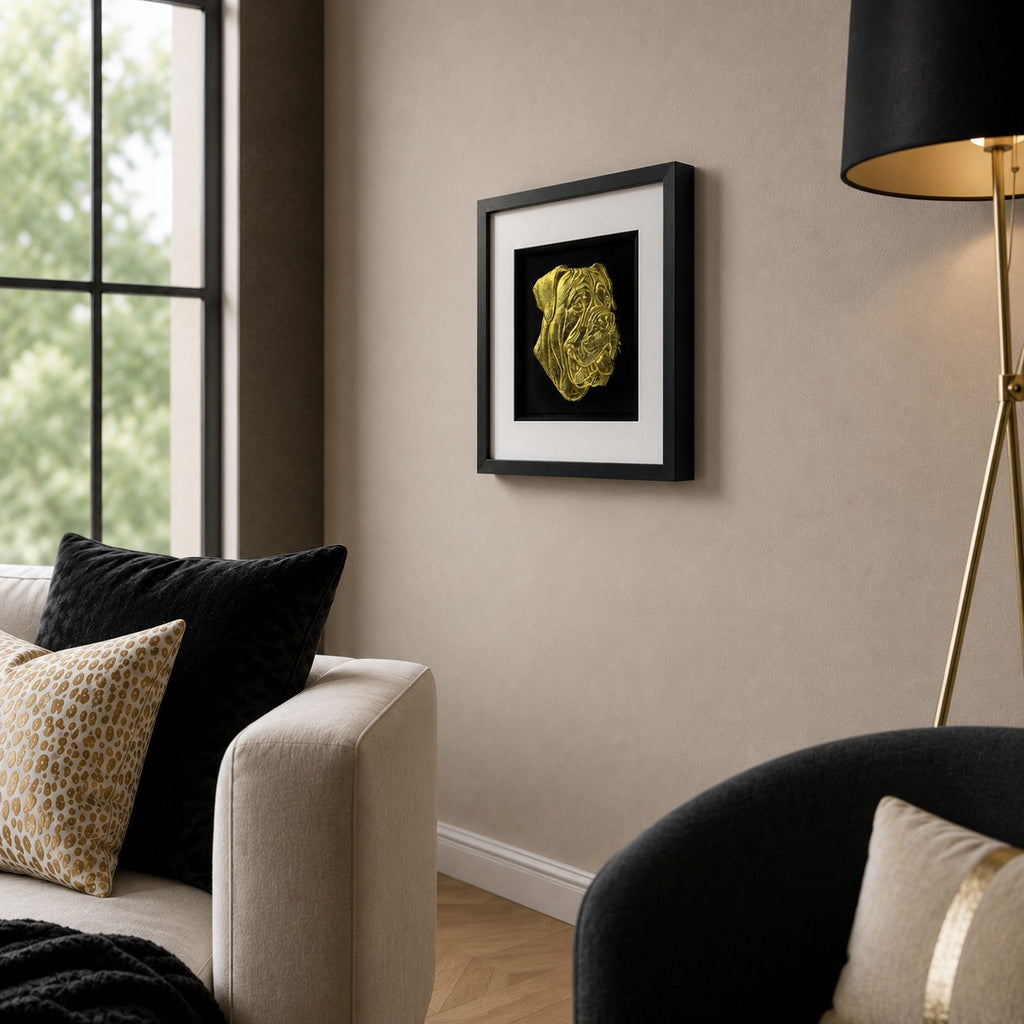 Angled lifestyle view of Cane Corso gold 3D dog wall art in a black frame with white mount, styled in a modern neutral living room.