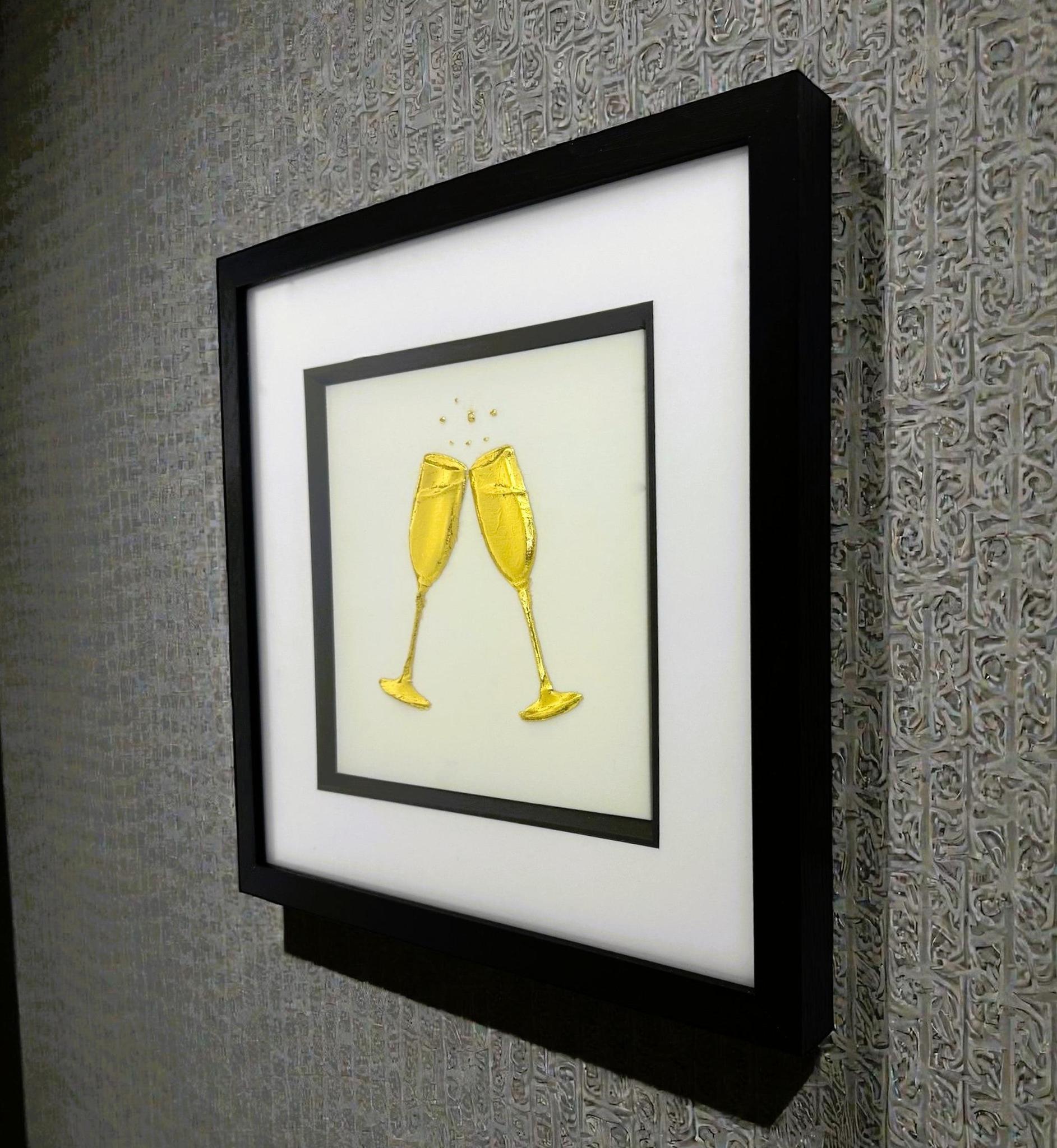 Angled wall-mounted view of champagne glasses wall art framed in black with white mount