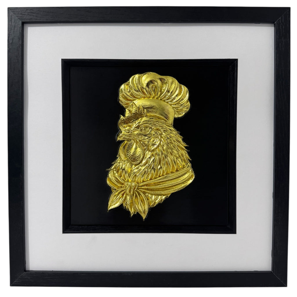 Gold chef rooster wall decor in a black box frame with wide white mount and black inner surround.