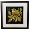 Framed Christmas robin wall art, gold relief of a robin on a holly branch with berries and silver snowflakes, on a black background in a black frame with white mount