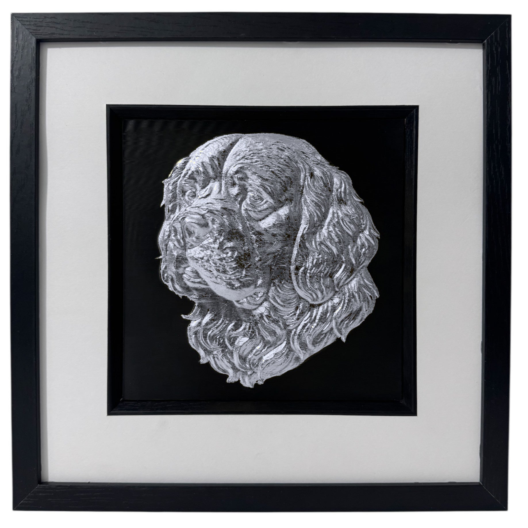 Silver Clumber Spaniel relief portrait in a black box frame with wide white mount and black inner surround.