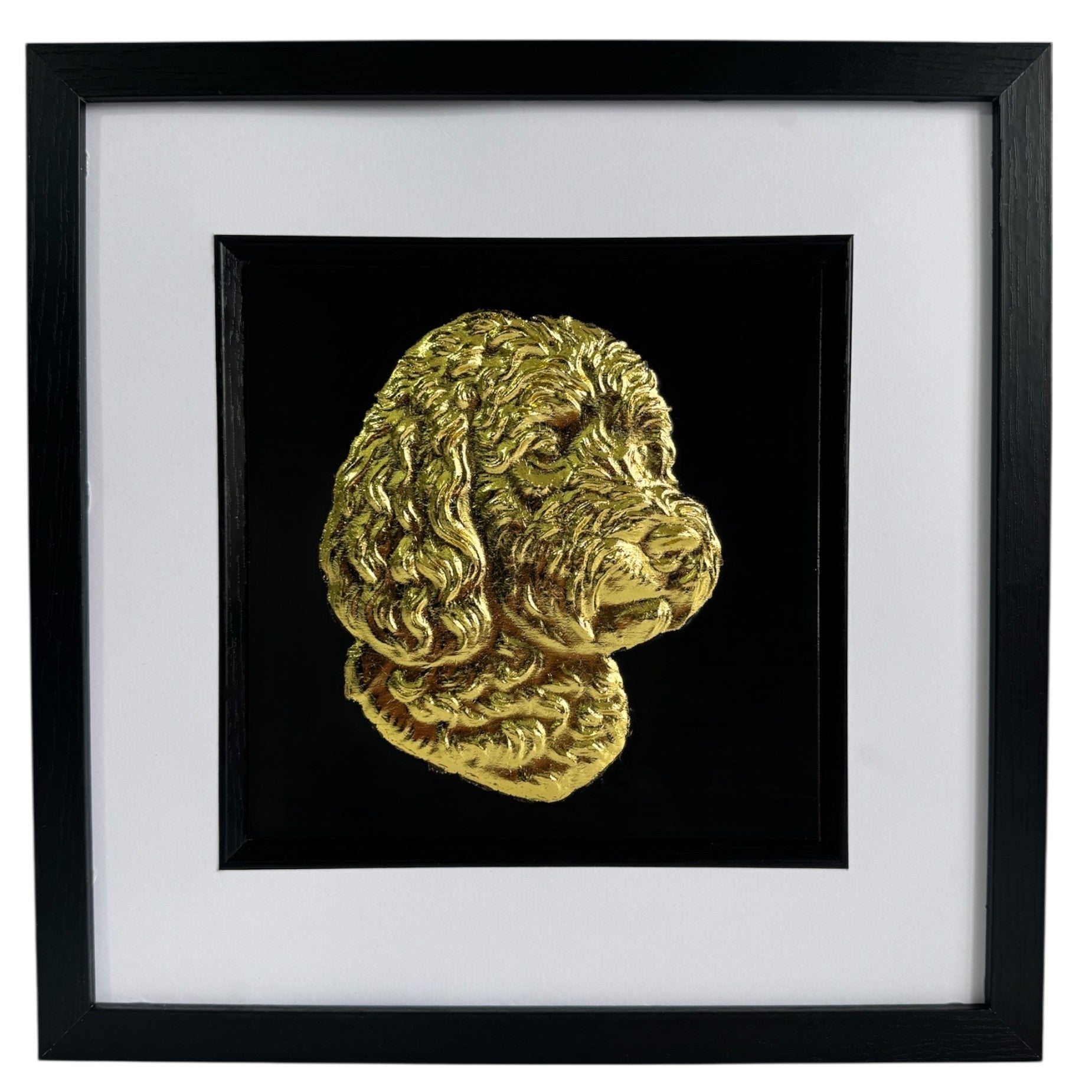 Framed cockapoo wall art with gold relief portrait on a black background, set in a black frame with white mount on a clean white background