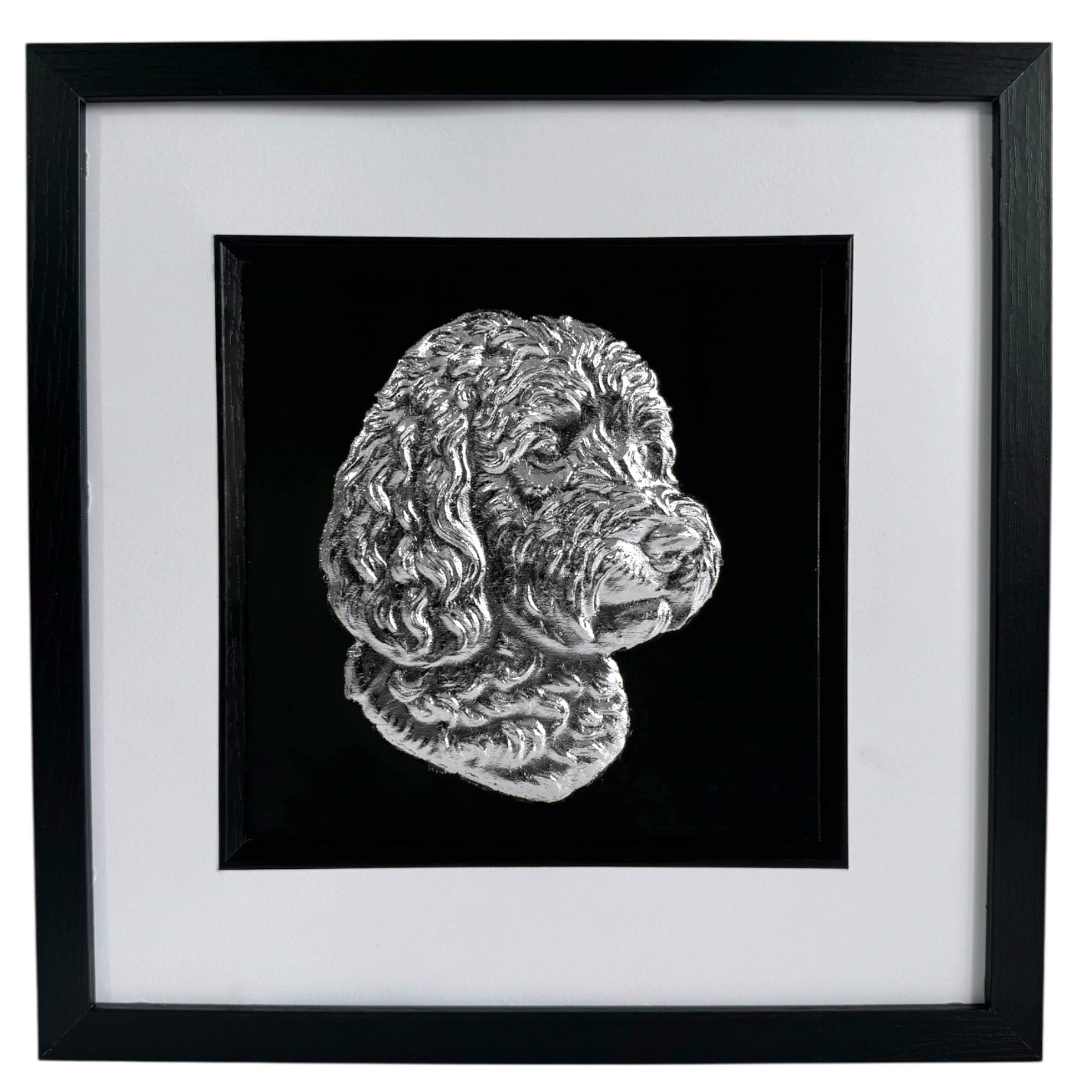 Framed cockapoo wall art with silver relief portrait on a black background, presented in a black frame with white mount on a pure white background