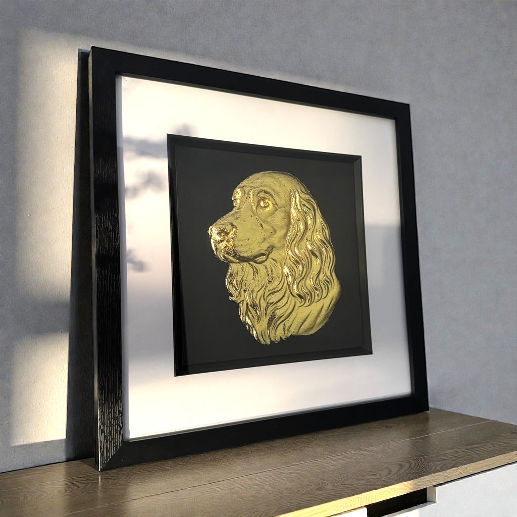 Cocker spaniel gold leaf in frame on a sideboard in modern interior