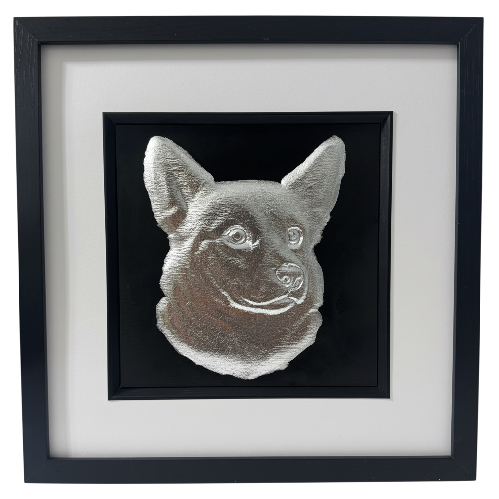 Framed corgi wall art with silver relief portrait on a black background, set in a black frame with white mount on a clean white background
