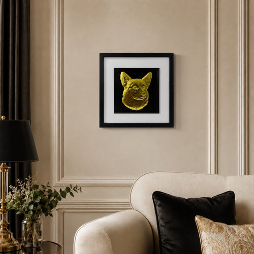 Corgi gold leaf framed dog wall art displayed above a cream sofa in a warm neutral living room with black and gold accents.