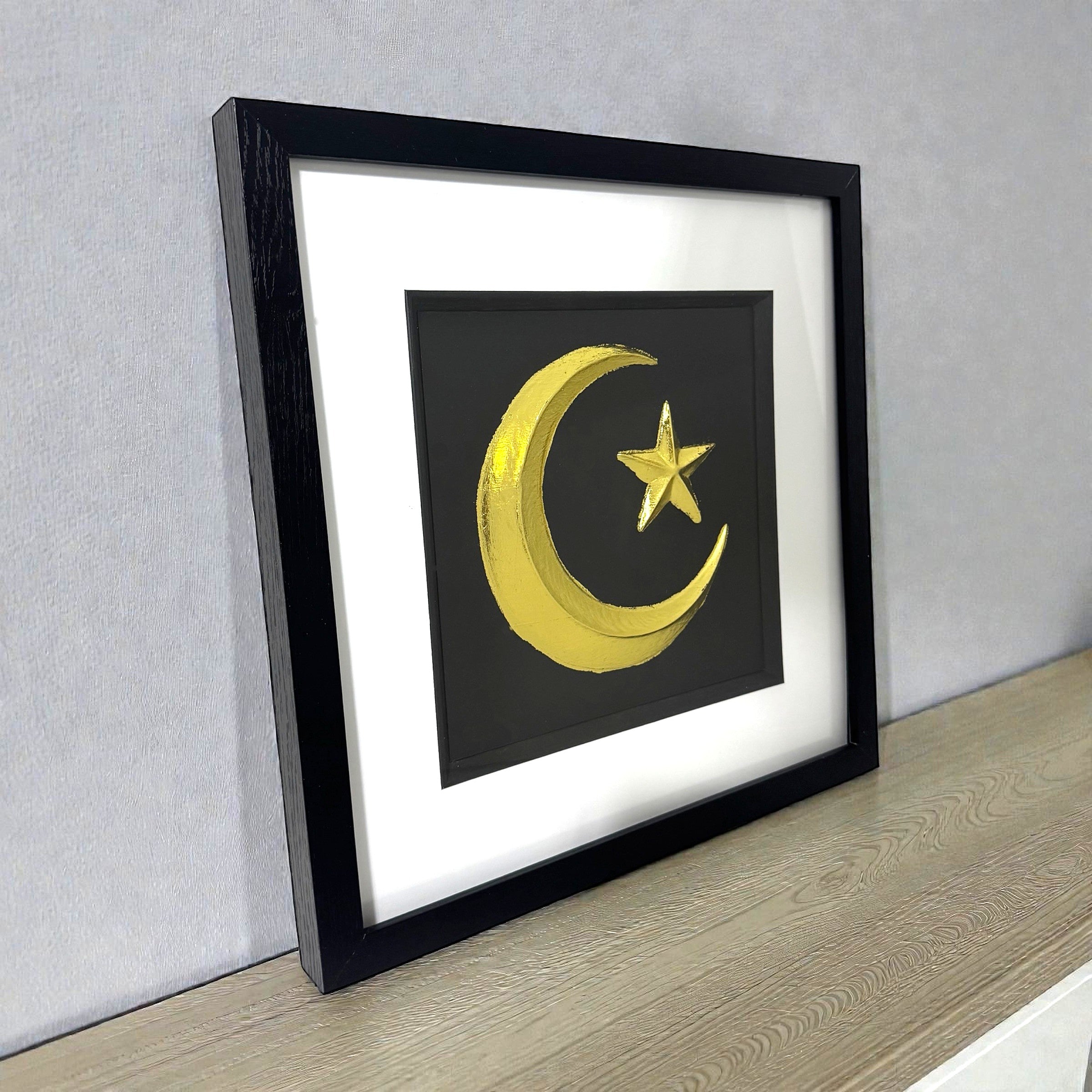 Side view of crescent moon and star wall art showing frame depth