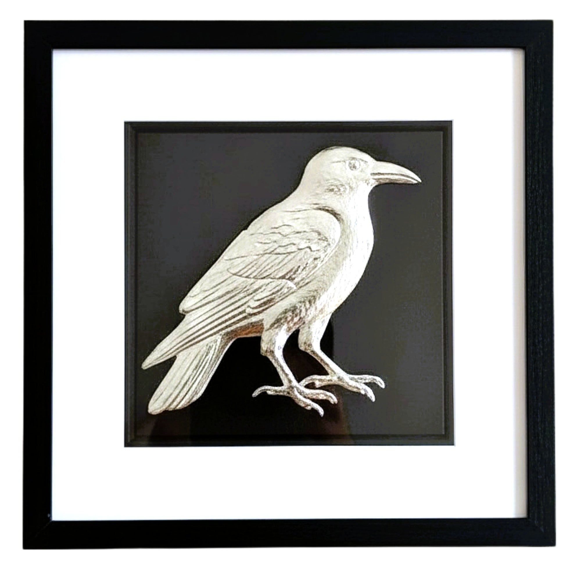 Front-facing silver leaf crow wall art on black background with white mount