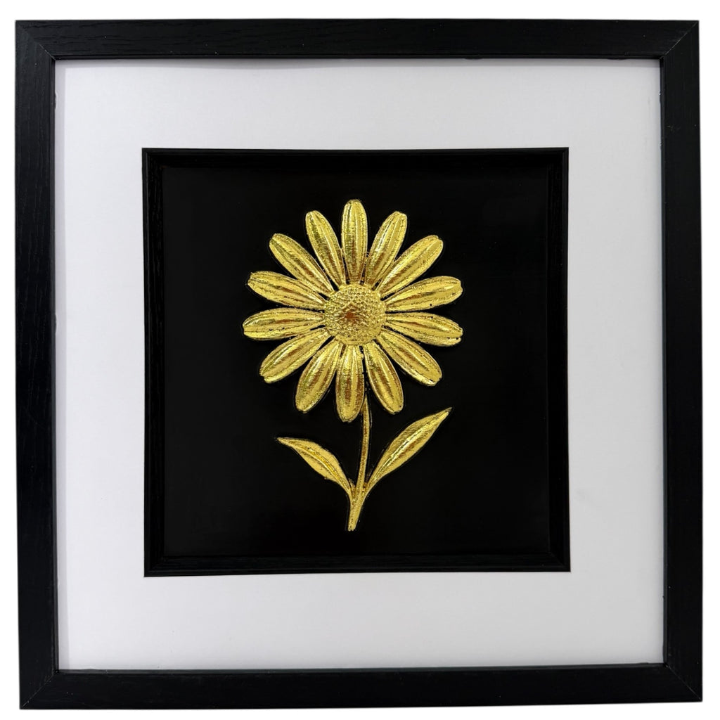 Gold daisy raised relief in a black frame with white mount and black inner surround on a white background.